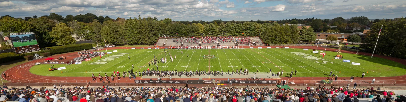 A football field inside a large open stadium