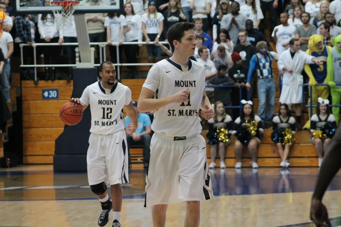 Basketball players competing on the court during a game