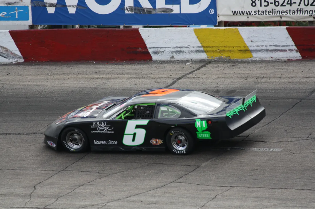 Stock cars racing on a speedway during a race