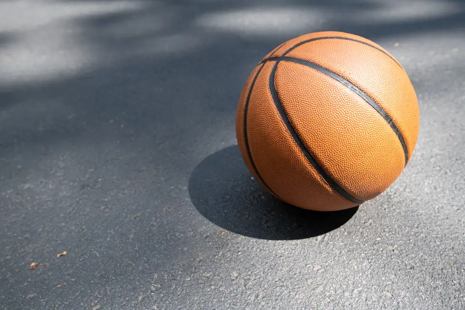 Close-up of a basketball resting on a hardwood court