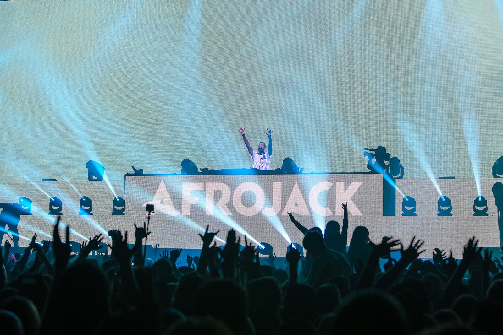 Afrojack performing with arms raised behind his DJ booth at the Ziggo Dome, Amsterdam, 2014