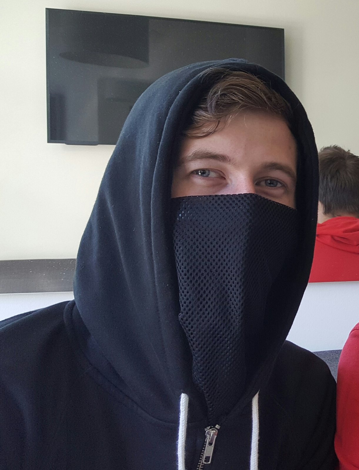Alan Walker in his trademark hood and mask during a Dance-Charts interview, 2016