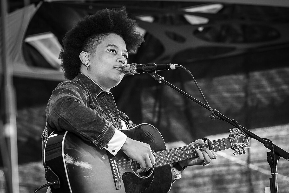 Amythyst Kiah performing with an acoustic guitar at the Purbeck Valley Folk Festival, England, 2022