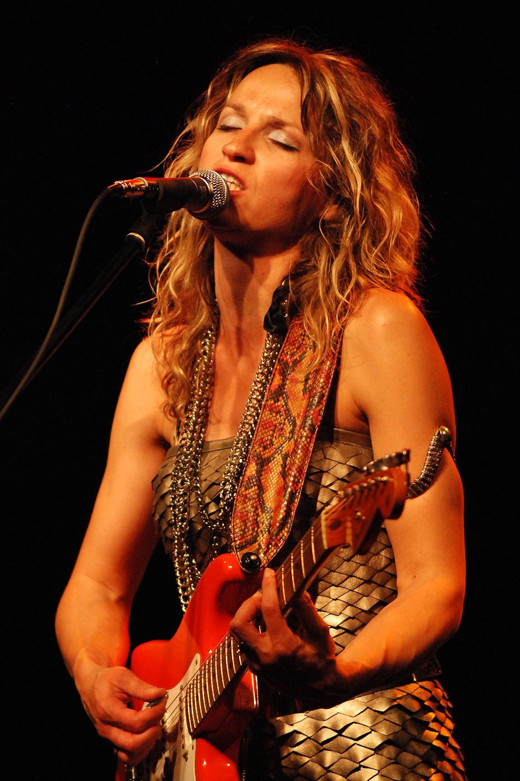 Ana Popovic singing and playing a red Stratocaster in concert, 2011