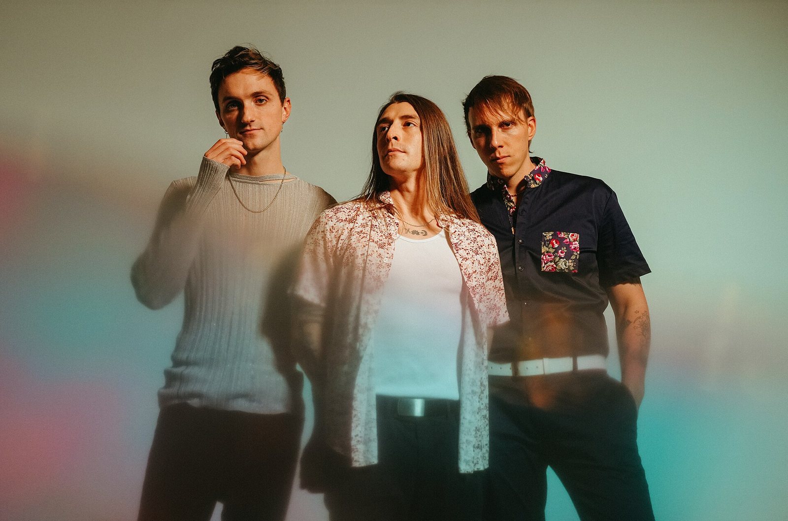 Arrows in Action, the three band members posed against a pastel backdrop in a portrait by Rachel Dwyer