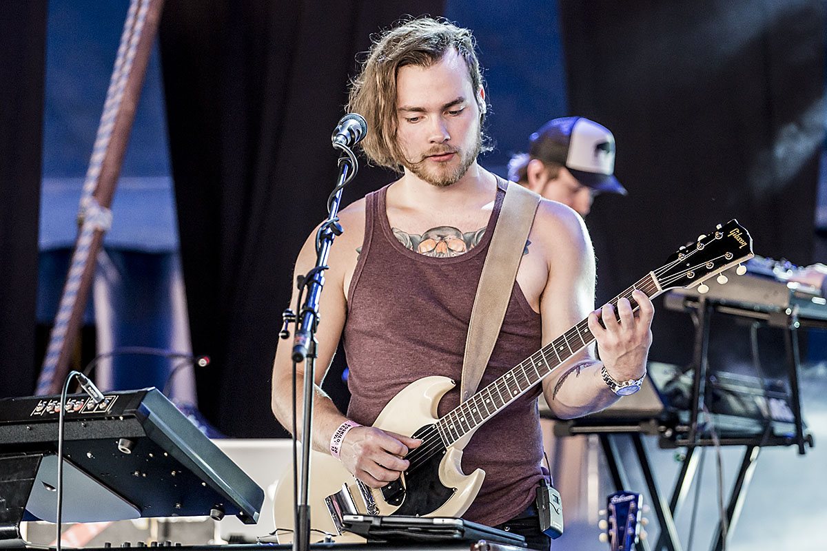 Ásgeir Trausti playing electric guitar on stage at Roskilde Festival, Denmark, July 6, 2013