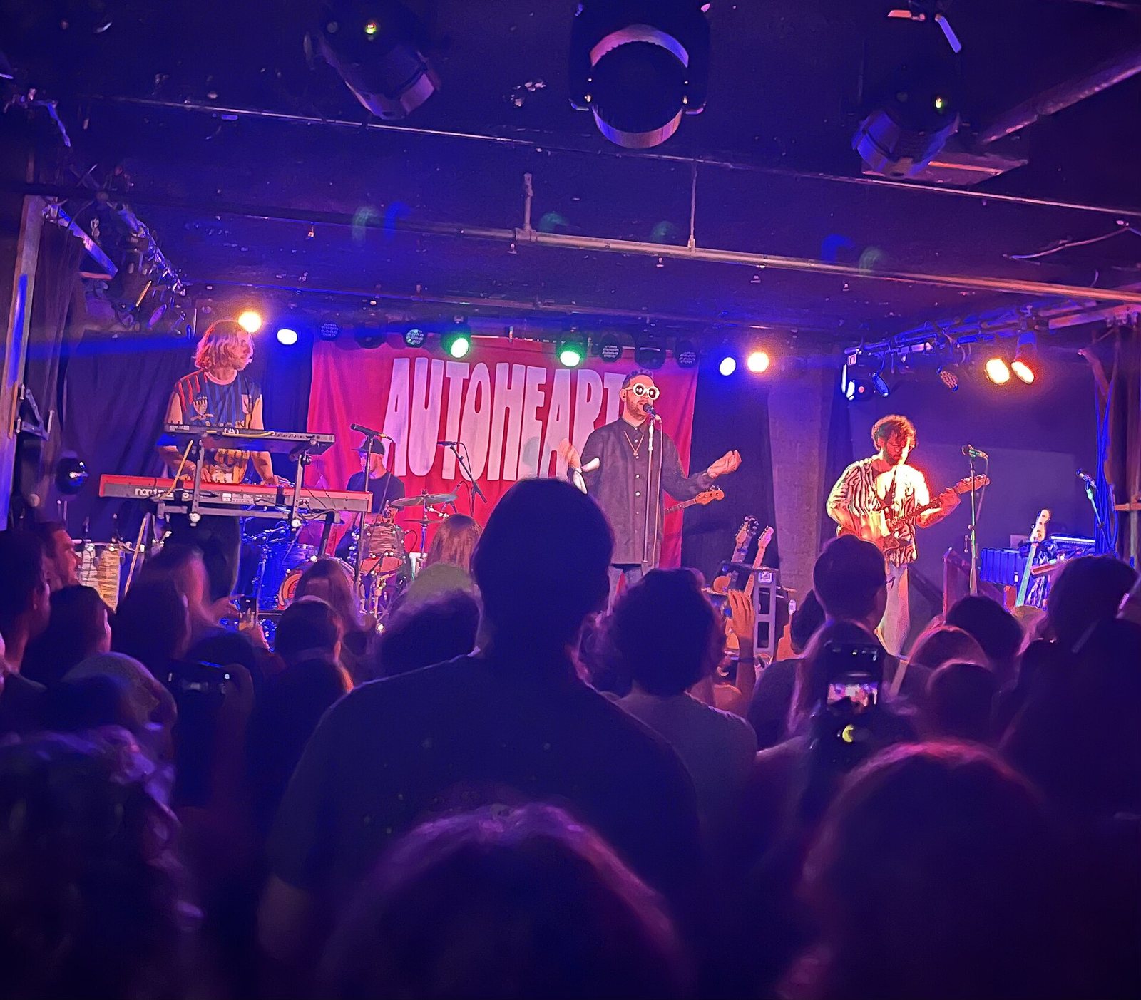 Autoheart performing live in front of their name banner in Atlanta, Georgia, 2024