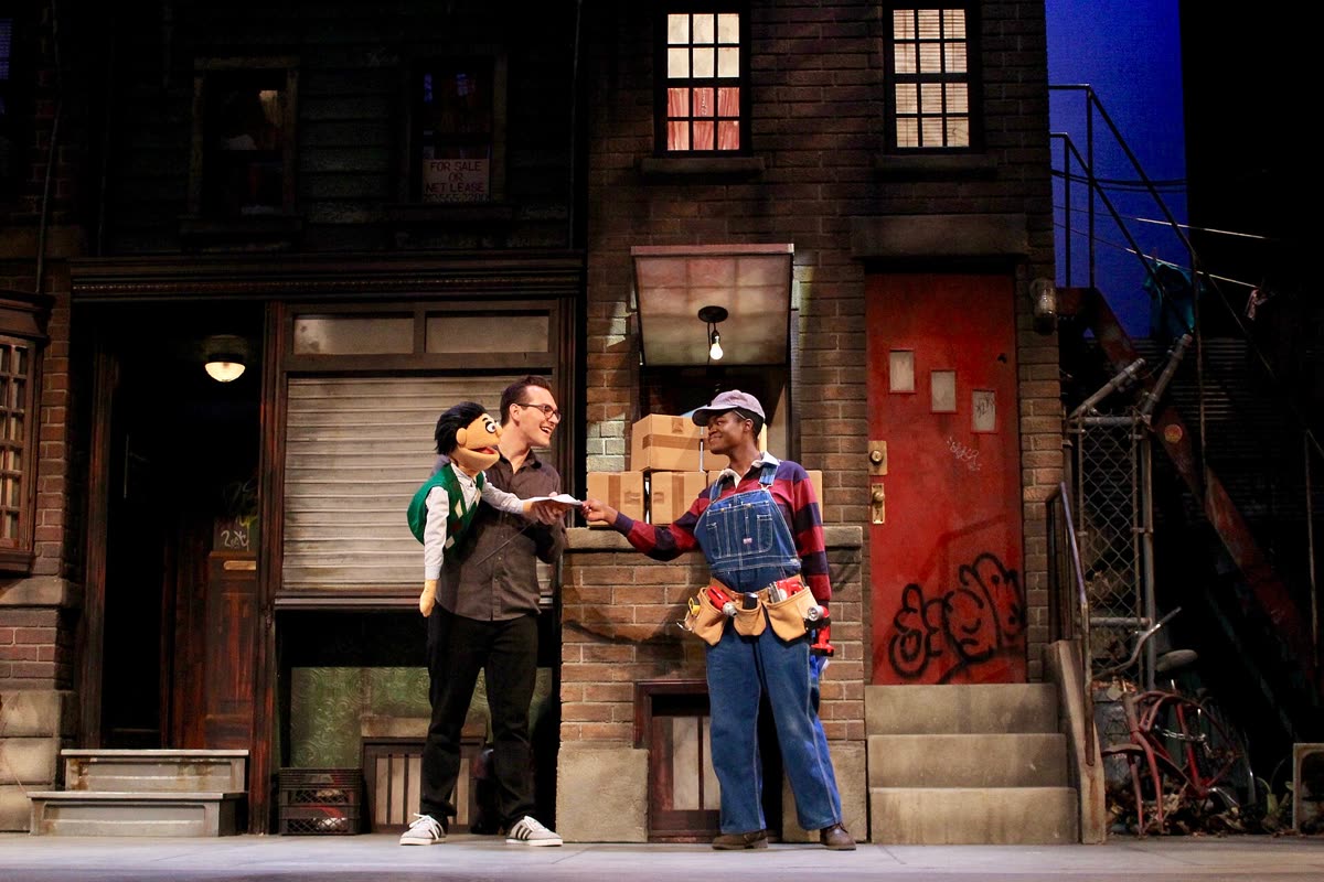Buy Avenue Q tickets on StubOrder Avenue Q stage production scene with puppets, University of Arkansas theatre