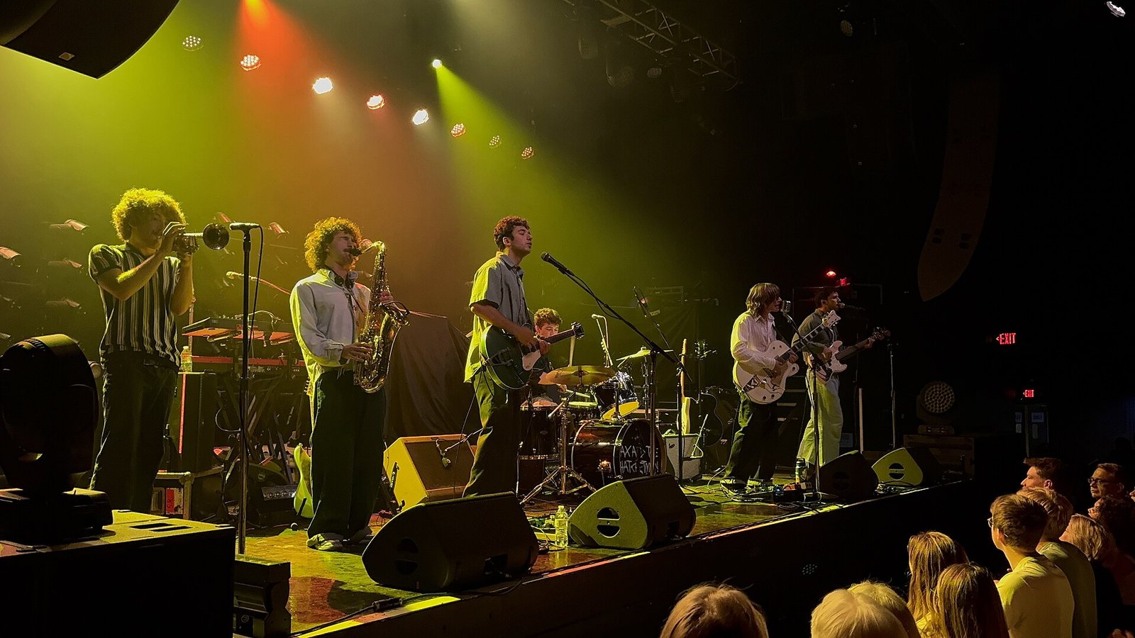 Ax and the Hatchetmen performing on stage with trumpet, saxophone and guitars, 2025