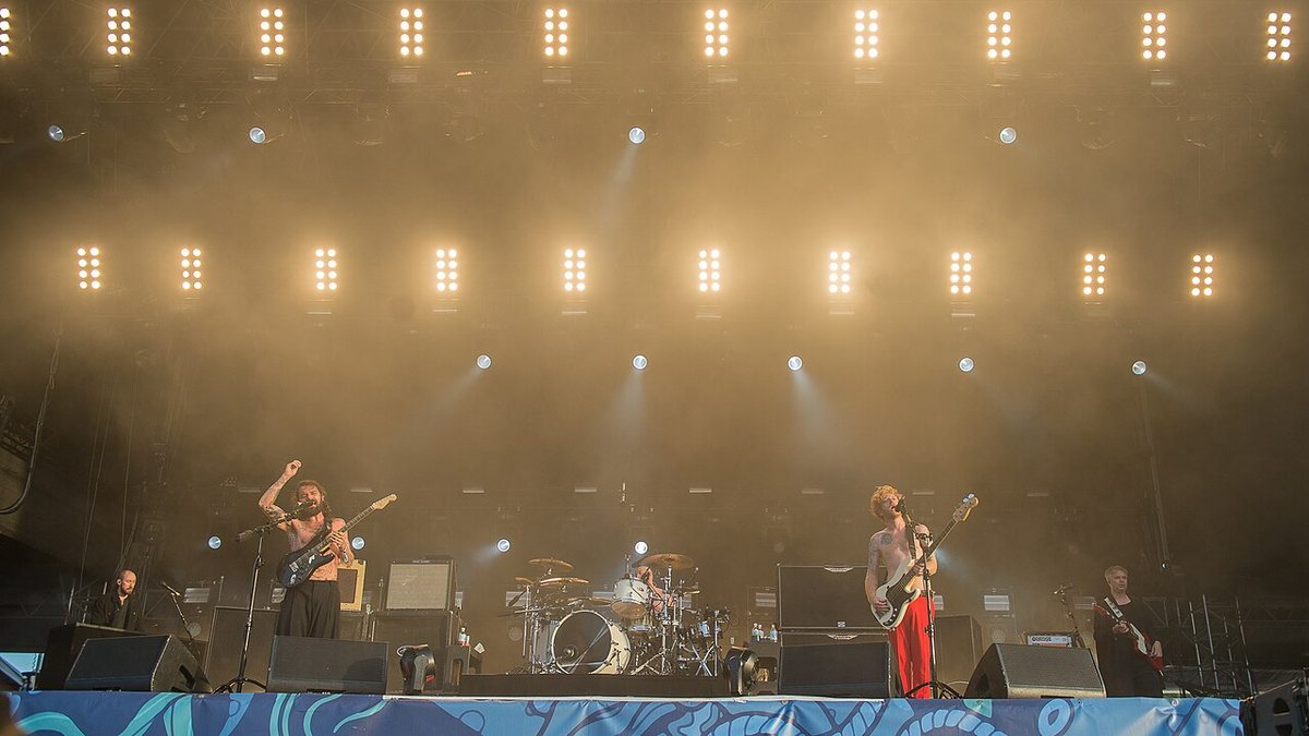 Buy Biffy Clyro tickets on StubOrder Biffy Clyro performing under stage lights on the Water Stage at Deichbrand Festival, Cuxhaven, 2017