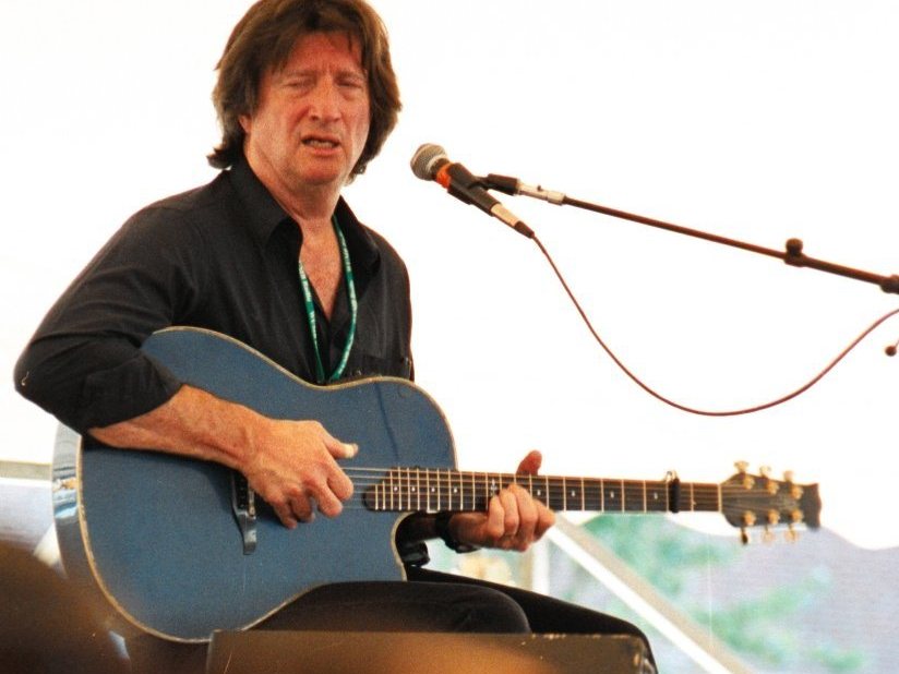 Chris Smither singing with guitar under the main tent at the New Bedford Folk Festival, 2004