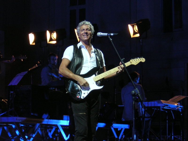 Buy Claudio Baglioni tickets on StubOrder Claudio Baglioni playing electric guitar on stage in concert