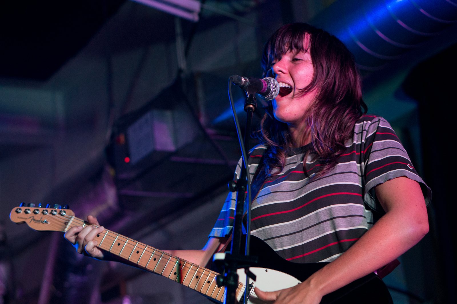 Courtney Barnett singing and playing guitar at Rough Trade East, London, 2015