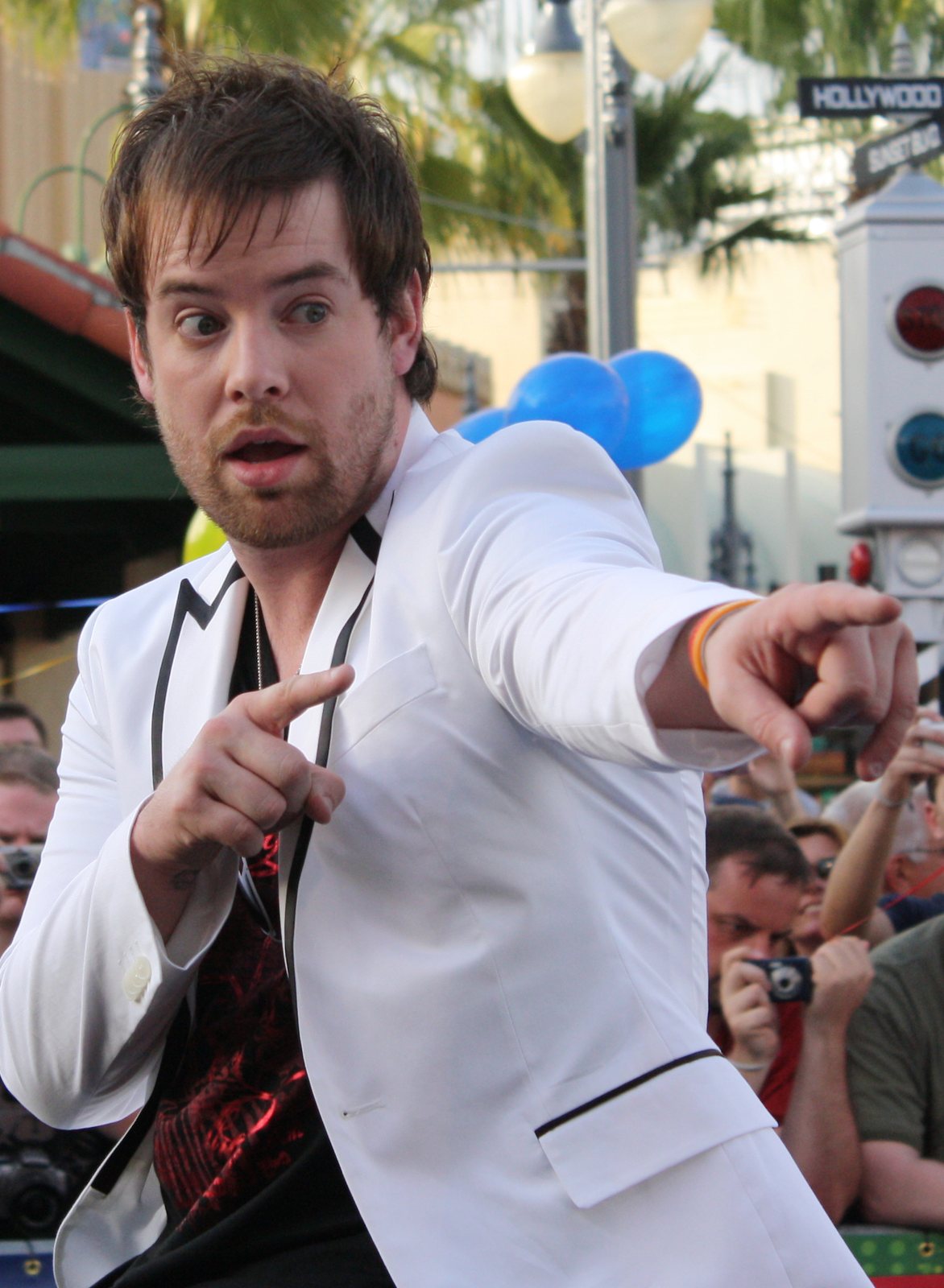 David Cook, winner of American Idol season seven, pointing toward fans at an outdoor event, 2009