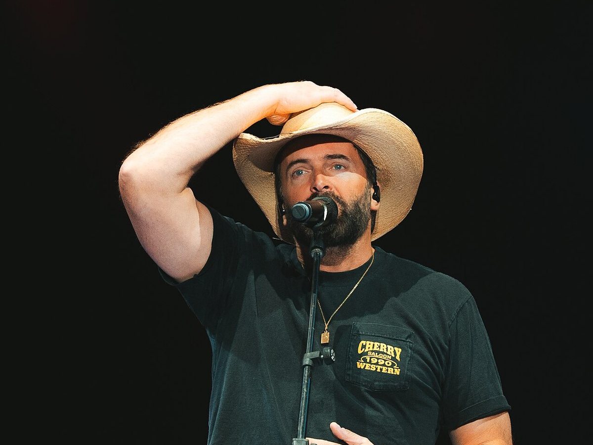 Buy Dean Brody & The Reklaws tickets on StubOrder Dean Brody singing at the microphone at the Canadian National Exhibition, Toronto, 2025