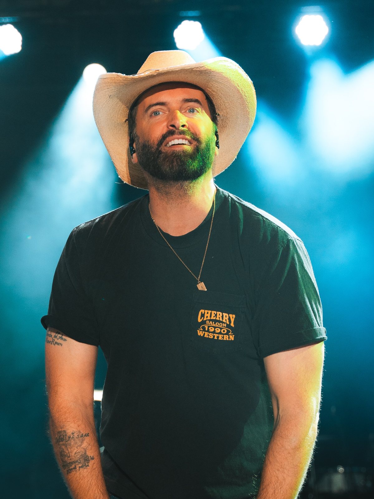 Dean Brody on stage under blue lights at the Canadian National Exhibition, Toronto, 2025