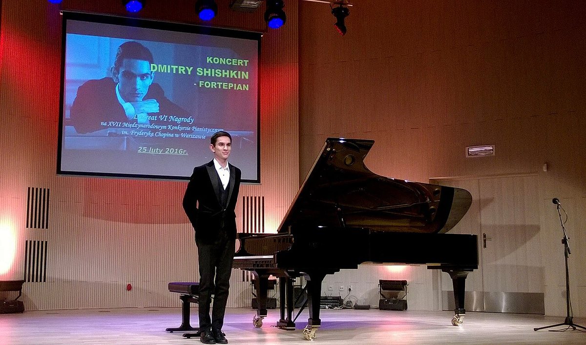 Dmitry Shishkin on stage beside a grand piano at his concert in Żywiec, Poland, 2016