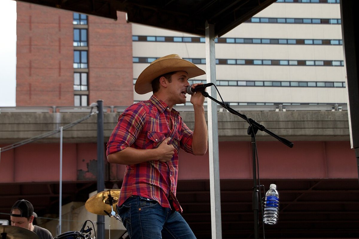 Dustin Lynch singing on an outdoor concert stage, 2012