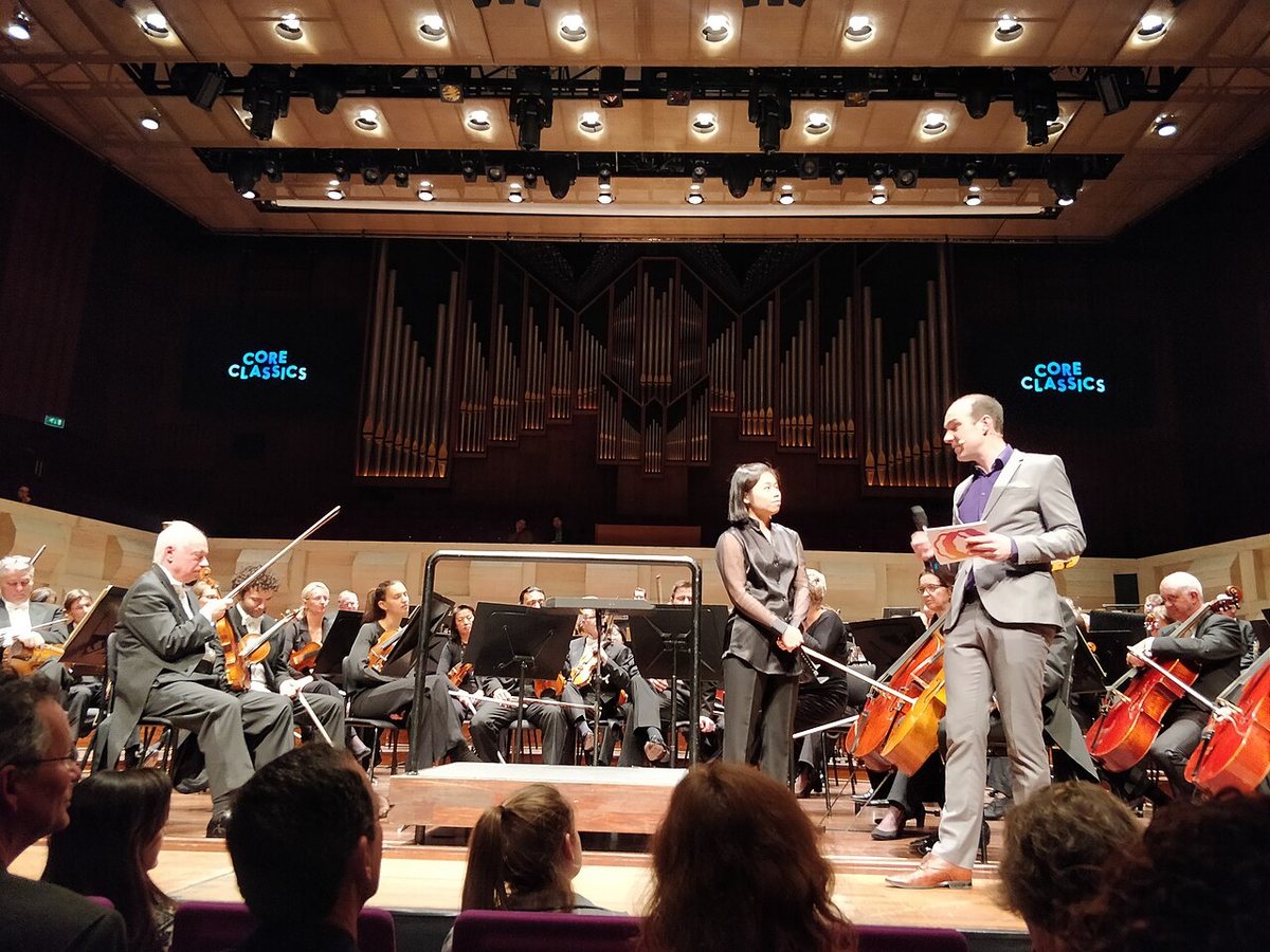Elim Chan on stage with an orchestra at De Doelen, Rotterdam