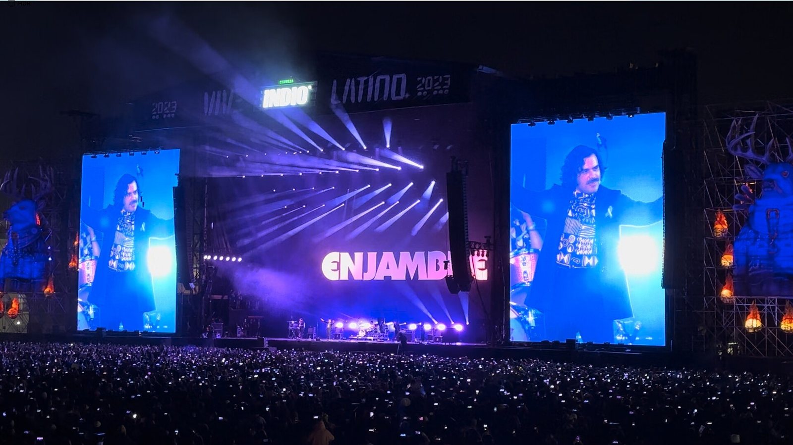 Enjambre on stage at Vive Latino 2023 in Mexico City, frontman Luis Humberto Navejas on the video screens