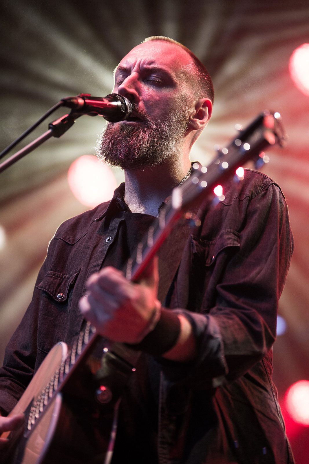 Fink singing and playing guitar on stage at the Rudolstadt Festival, Germany, 2014
