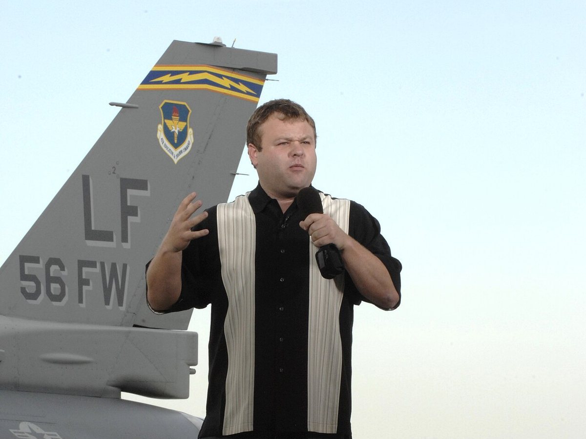 Frank Caliendo performing on an outdoor stage at Luke Air Force Base, Arizona, November 2009