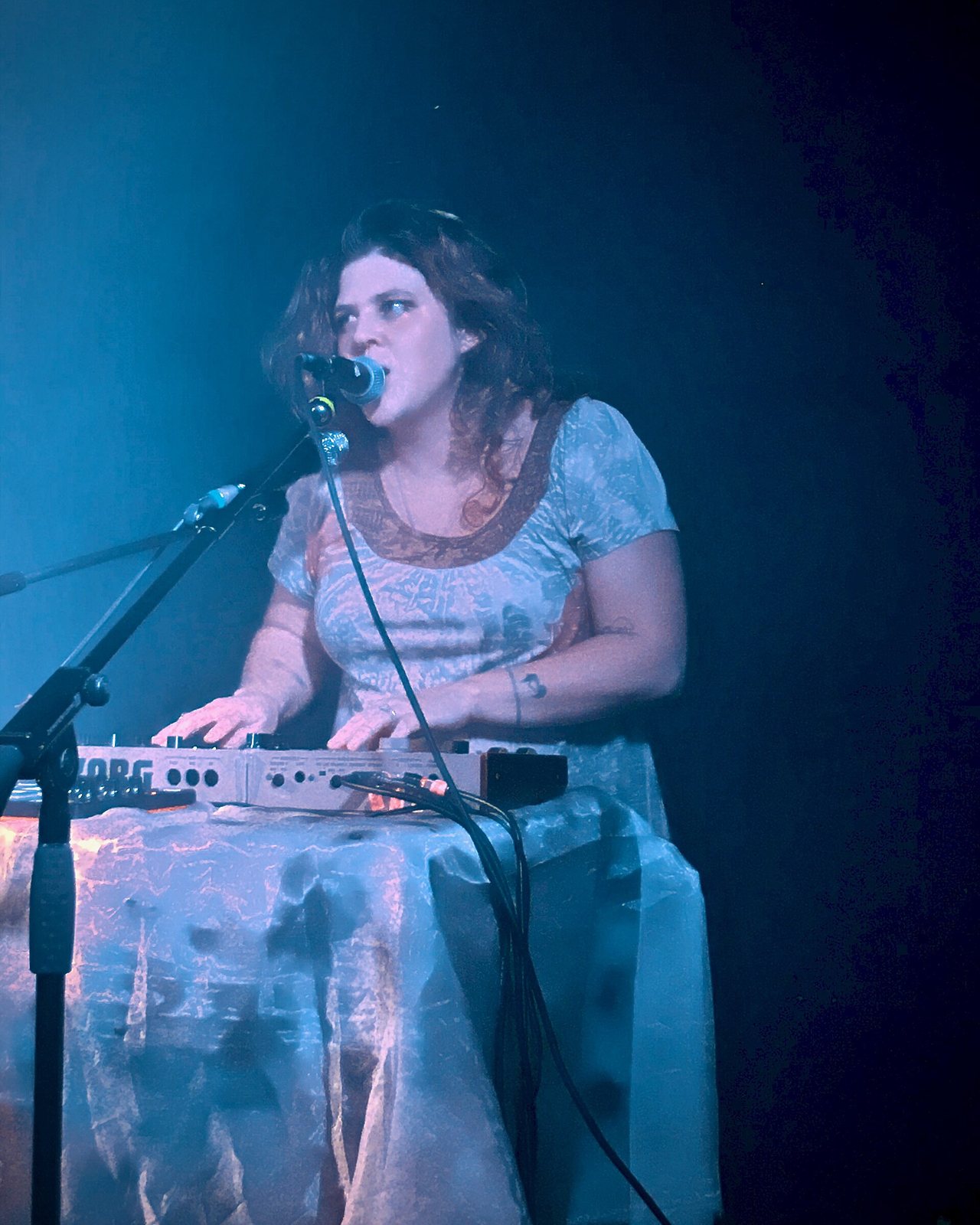 Grace Ives singing at a keyboard at Yes Basement, Manchester, England, 2022