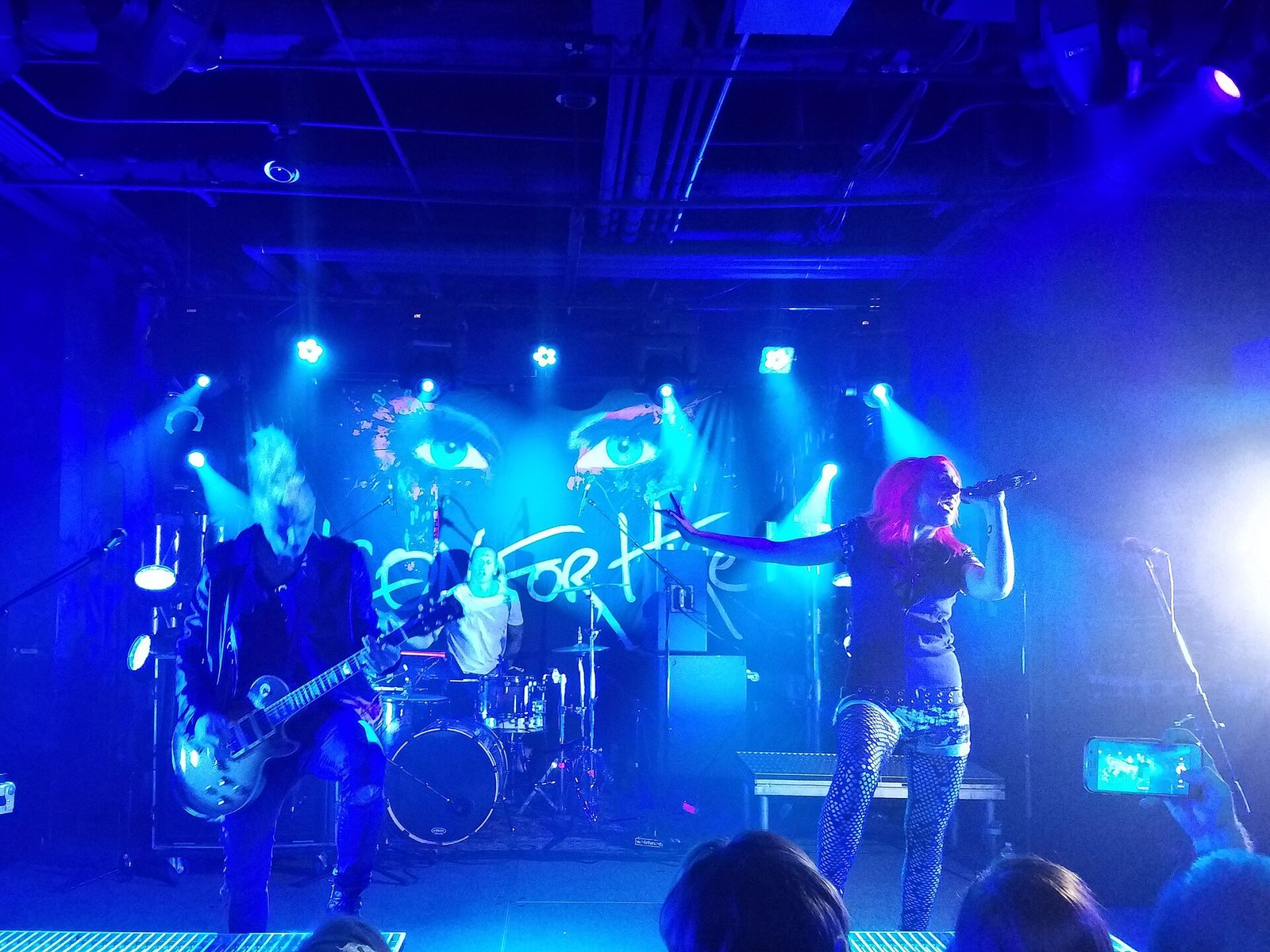 Icon for Hire performing live in front of their eye-themed backdrop, 2016