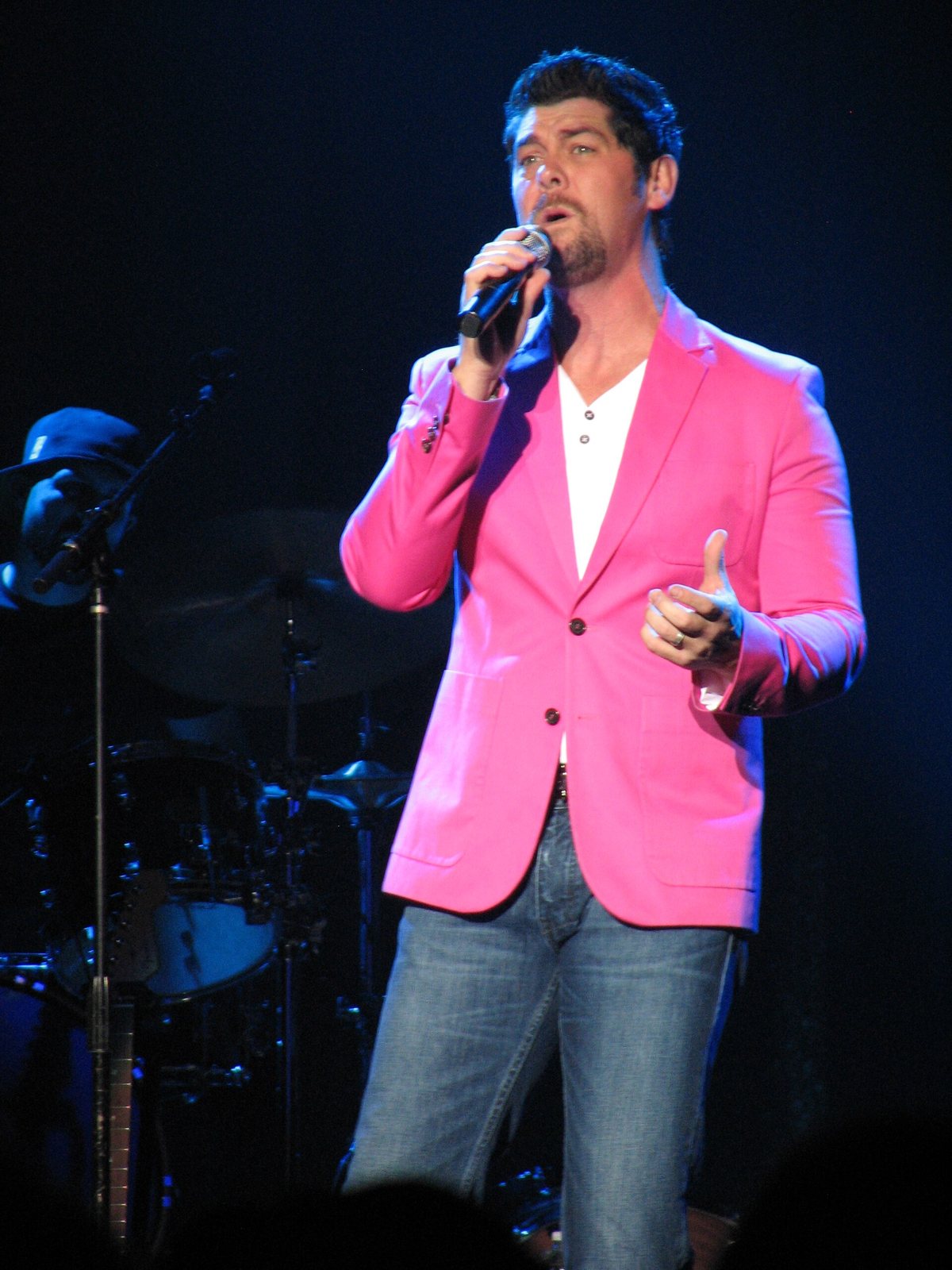 Jason Crabb singing on stage in a pink jacket, October 2013