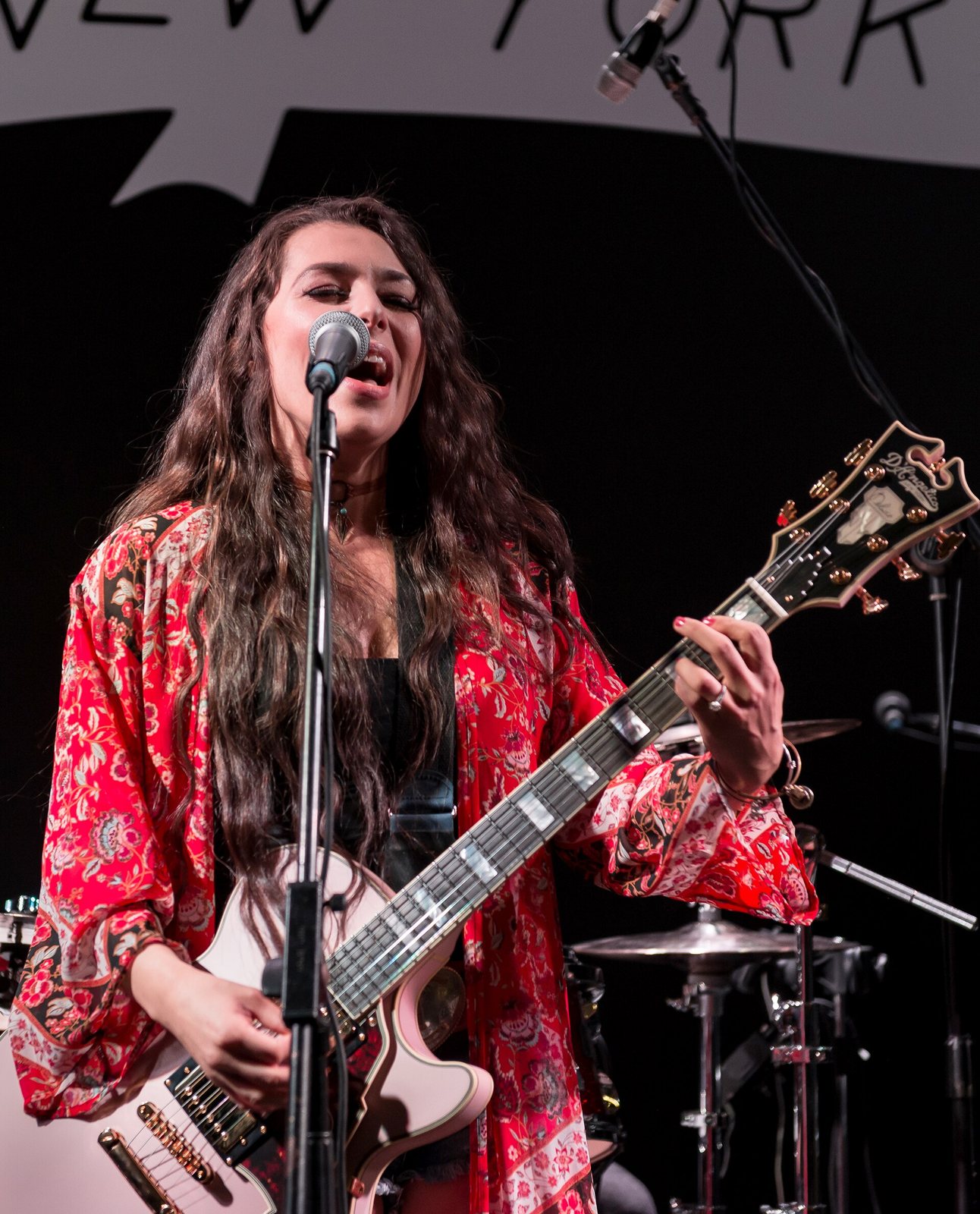 Jessica Lynn singing and playing guitar at the Winter NAMM Show, Anaheim, California, 2018