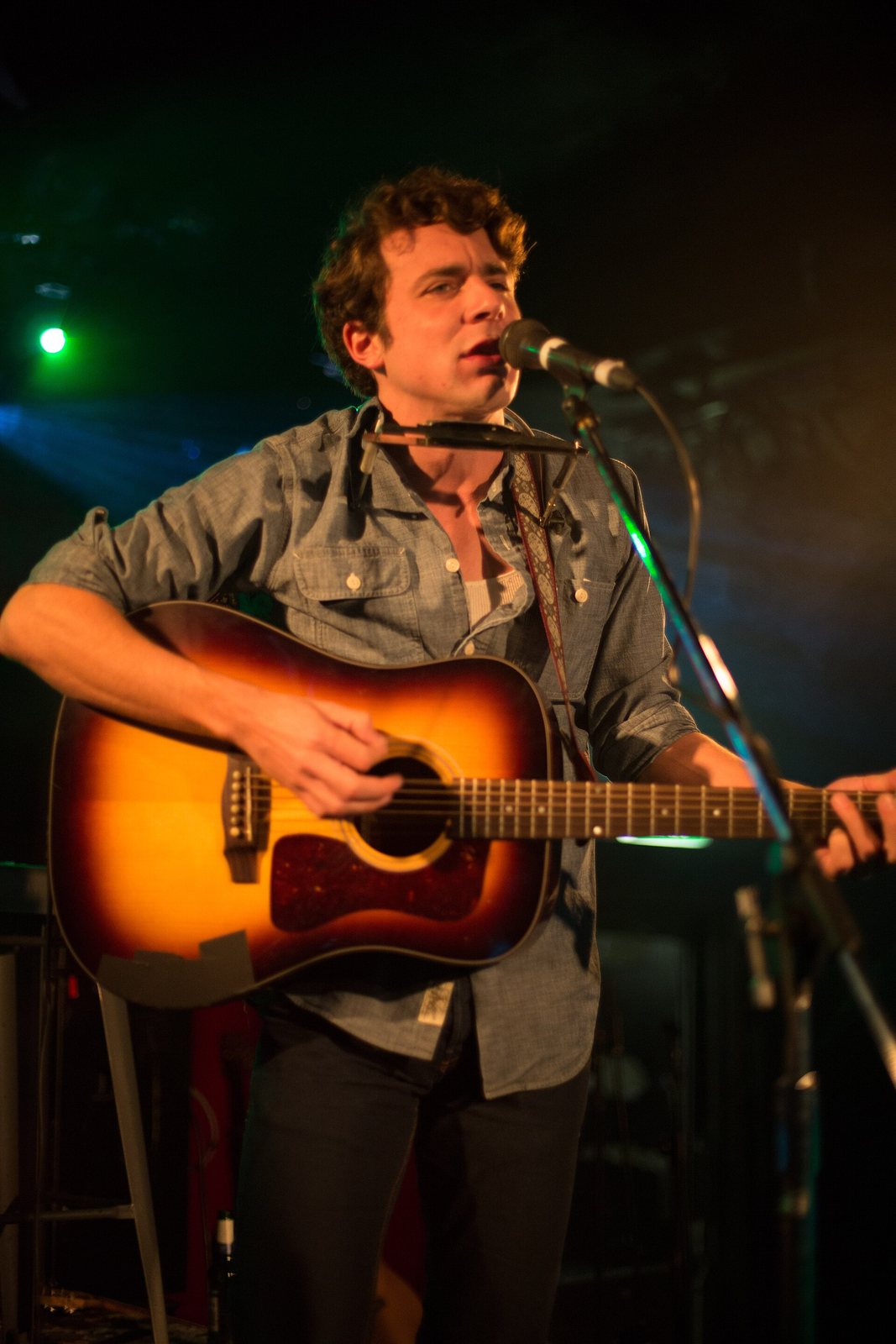 Joe Pug singing and playing acoustic guitar on stage, November 2012