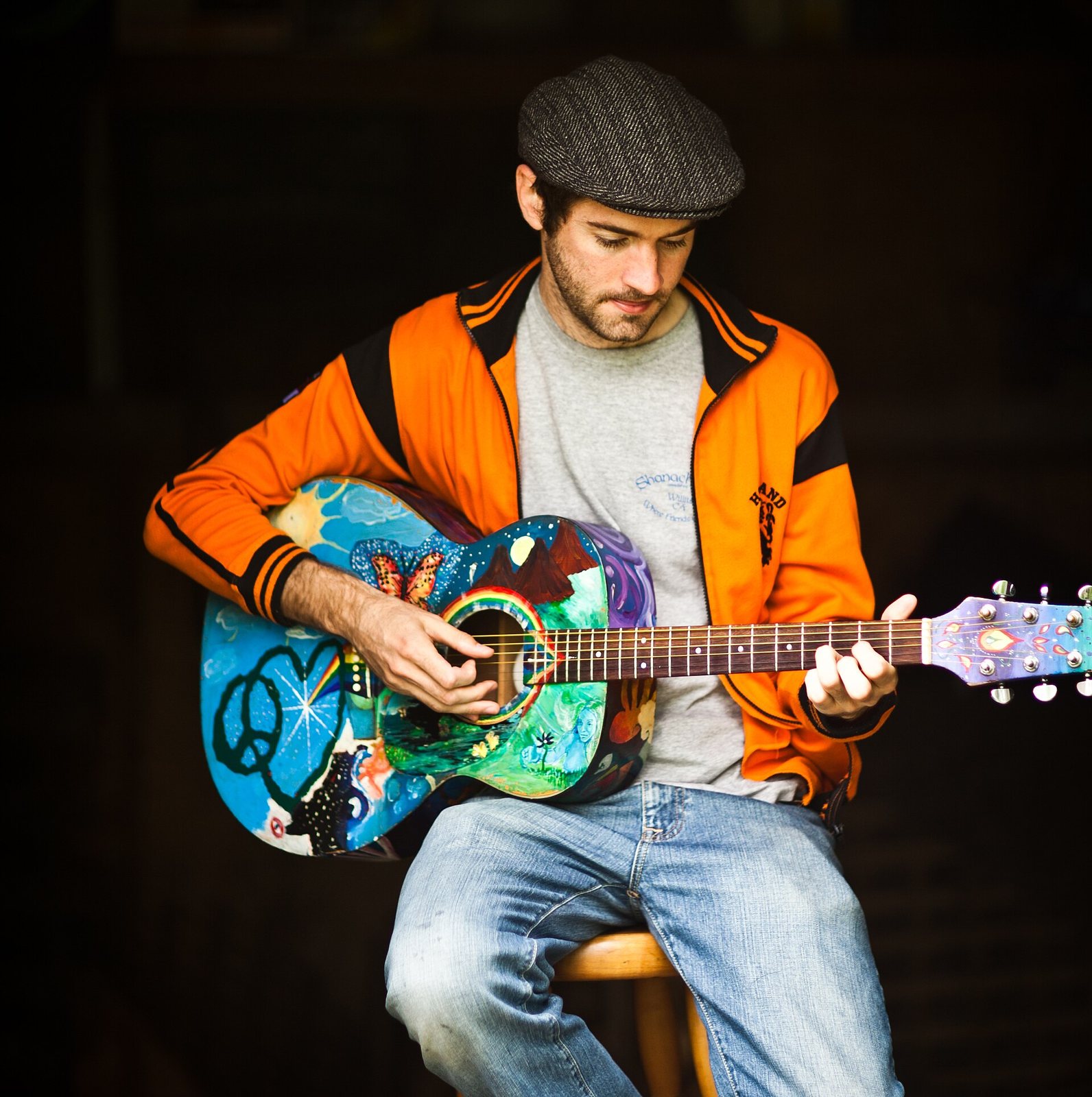Singer-songwriter John Craigie playing a hand-painted acoustic guitar