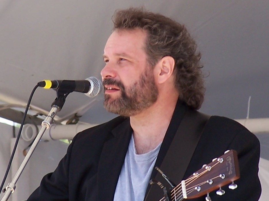 John Gorka singing with an acoustic guitar at the Falcon Ridge Folk Festival, 2004