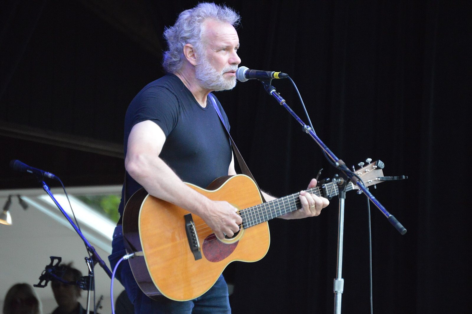John Gorka performing with an acoustic guitar at the Philadelphia Folk Festival, 2018