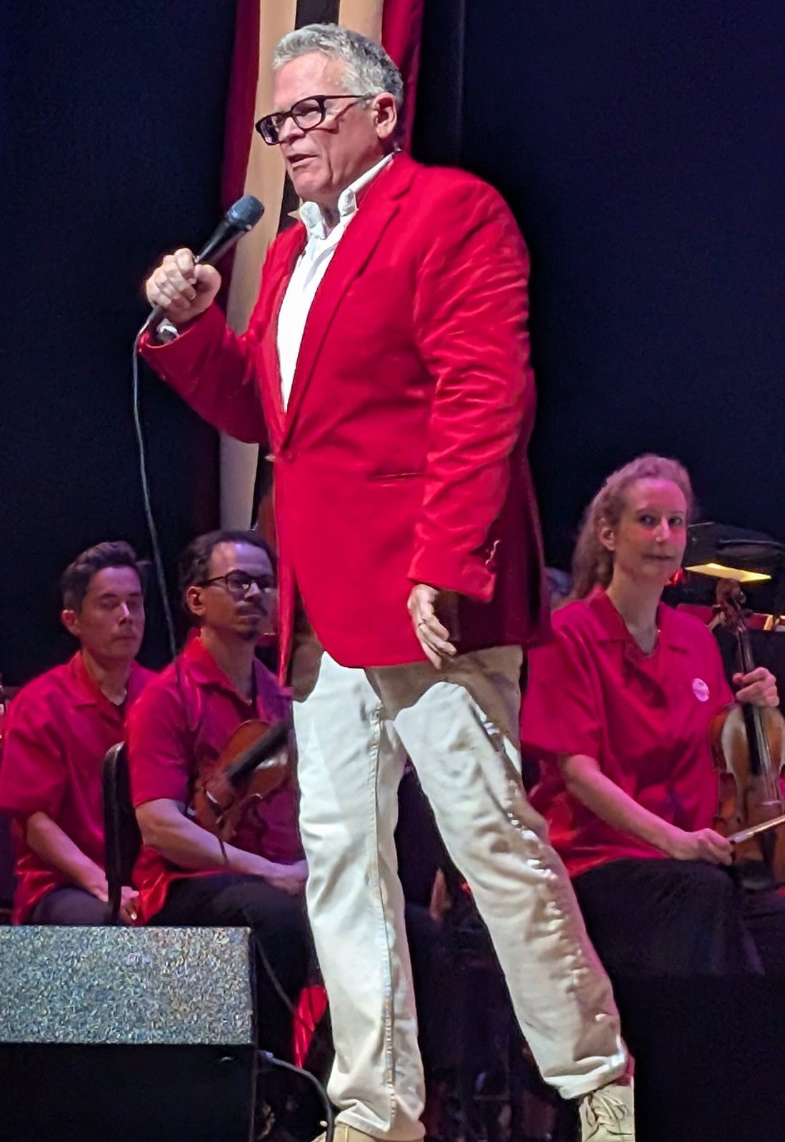 John Morris Russell on stage with a microphone at Riverbend Music Center, Cincinnati, July 4, 2025