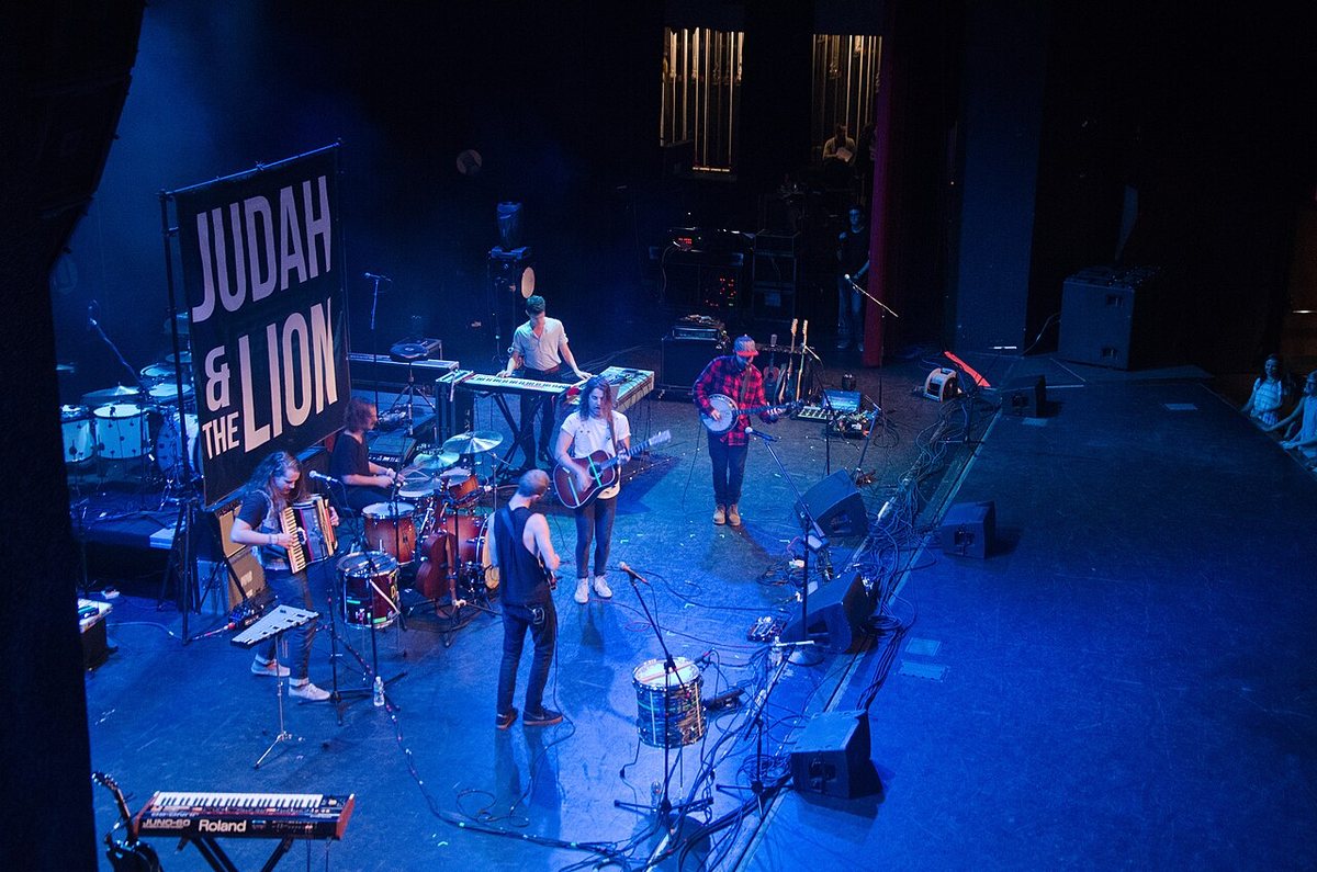 Judah and the Lion on stage beneath their band banner at Texas A&M University, 2015