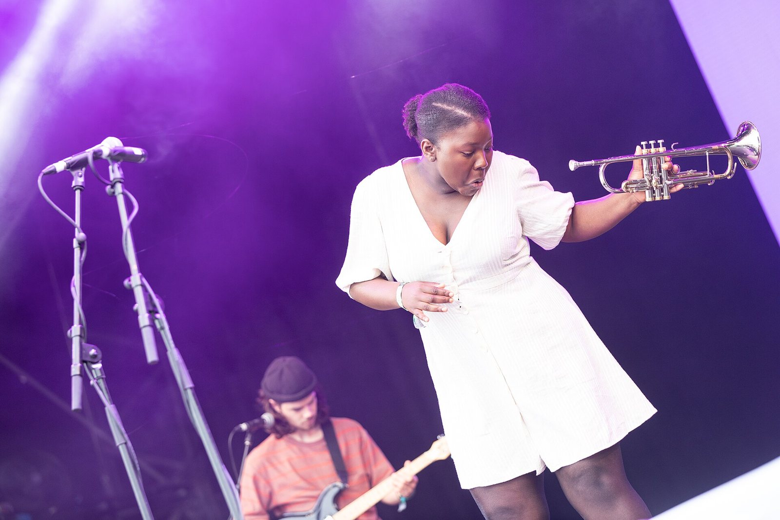 Kokoroko's trumpeter dancing on the West Holts stage at Glastonbury Festival, 2019, with the guitarist behind