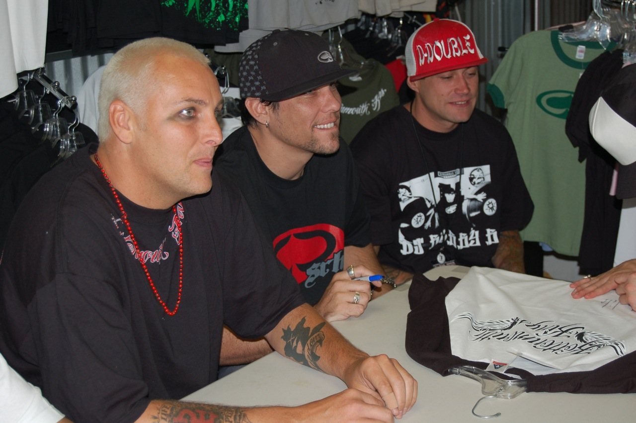 Kottonmouth Kings members at a fan autograph signing table, 2006
