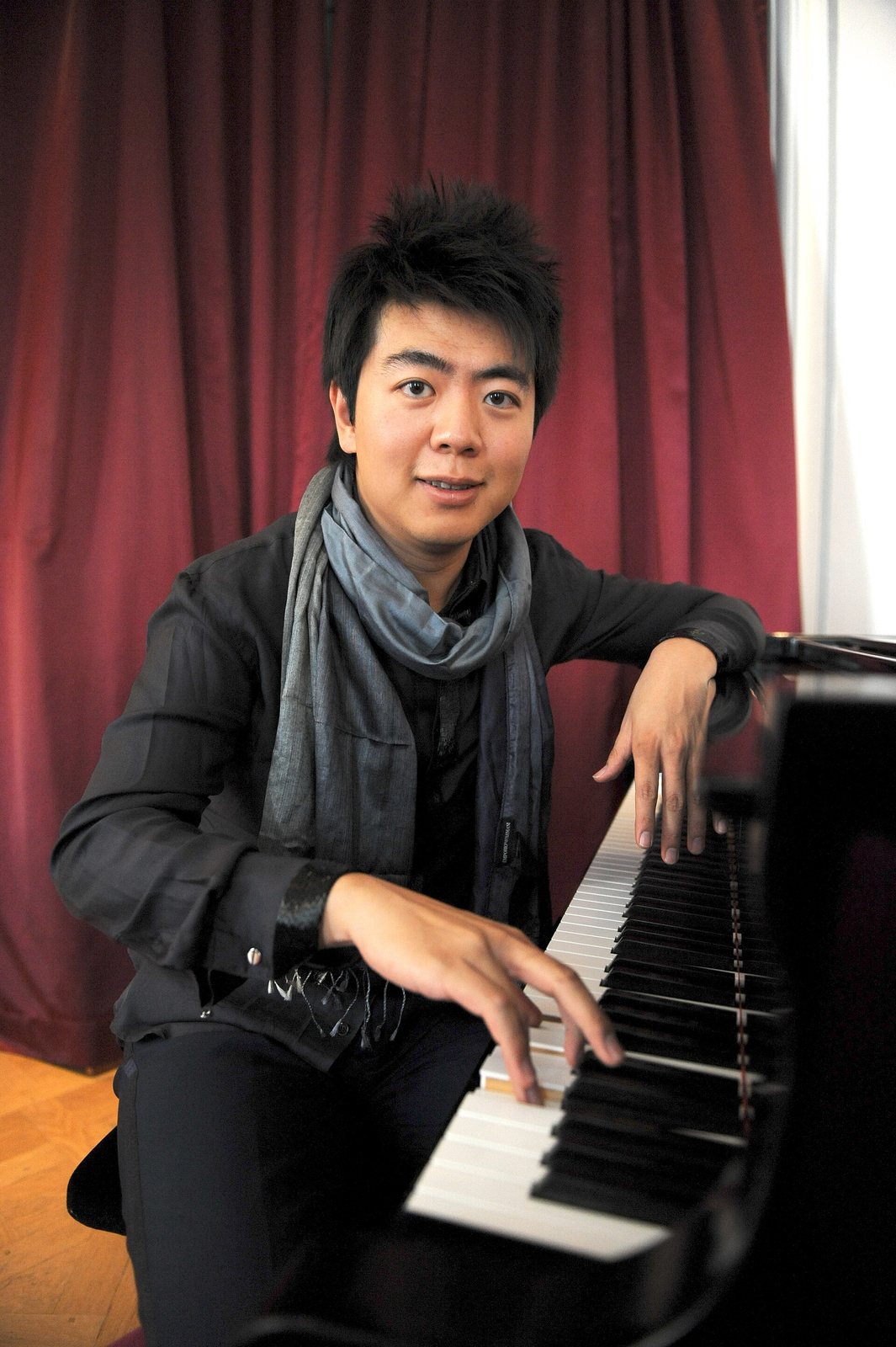 Pianist Lang Lang seated at a grand piano in Paris, August 2010