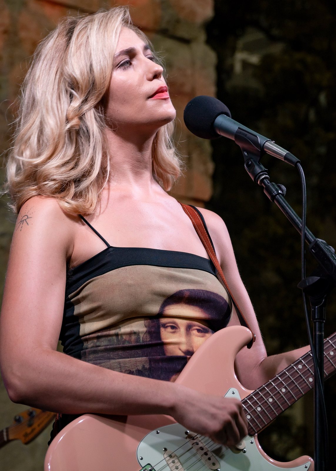 Lola Kirke singing and playing guitar in concert at the Getty Museum, Los Angeles, 2018