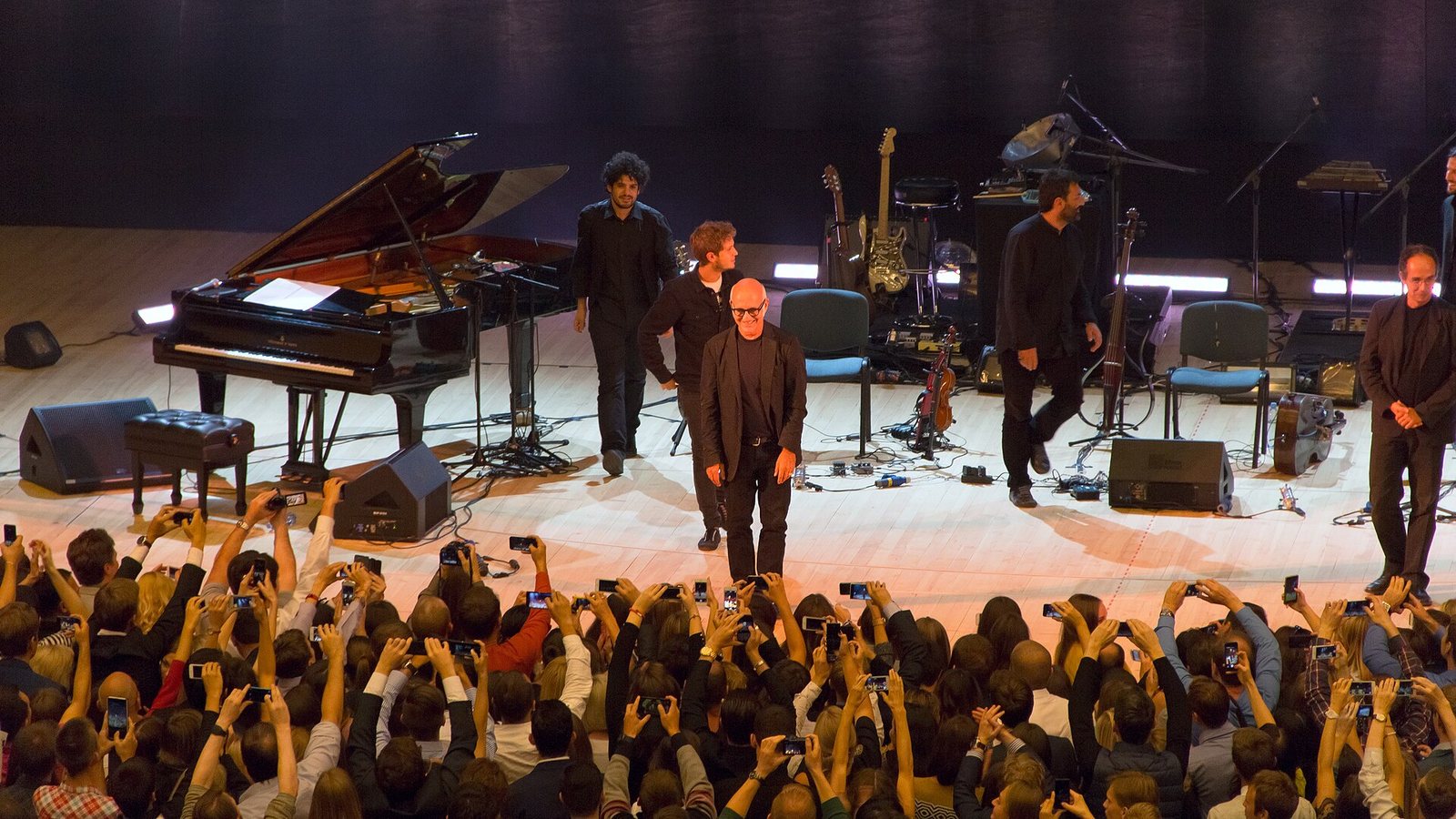 Ludovico Einaudi on stage with his band acknowledging applause after a concert in Moscow, September 2014