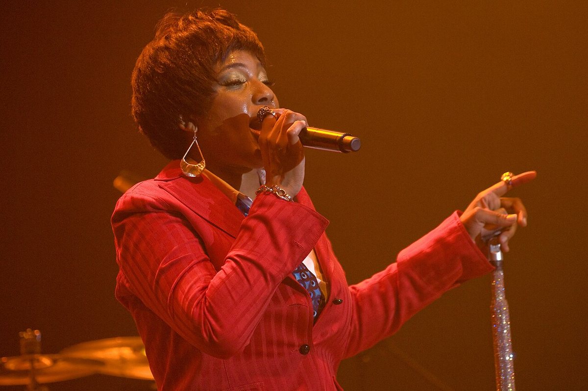 Buy Macy Gray tickets on StubOrder Macy Gray singing in a red suit on stage in concert, 2008