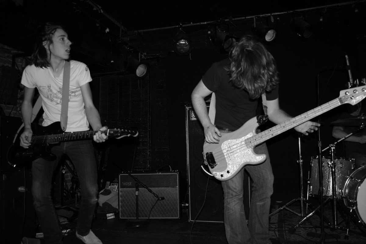 Manchester Orchestra guitarist and bassist performing on a club stage, 2007, black and white