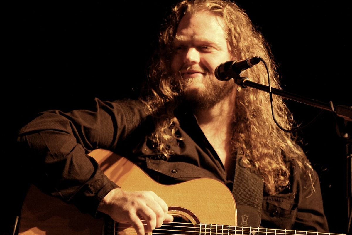 Matt Andersen playing acoustic guitar on stage, 2012
