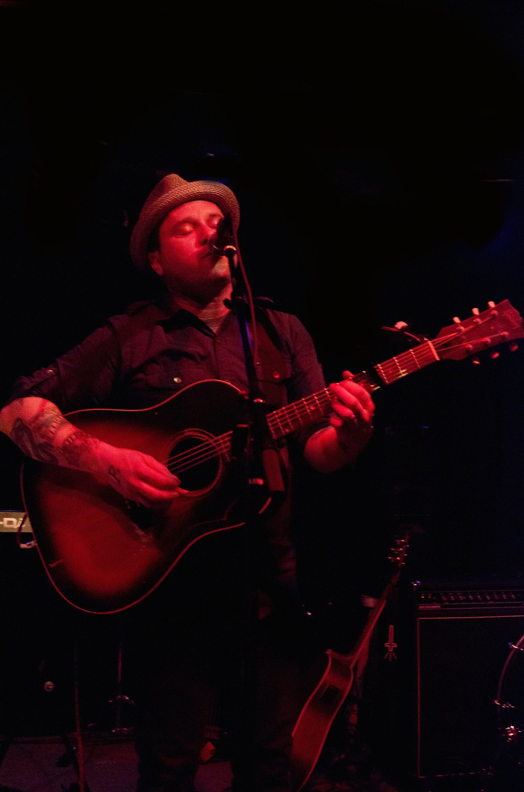 Matt Pryor singing with an acoustic guitar during a live performance, 2010