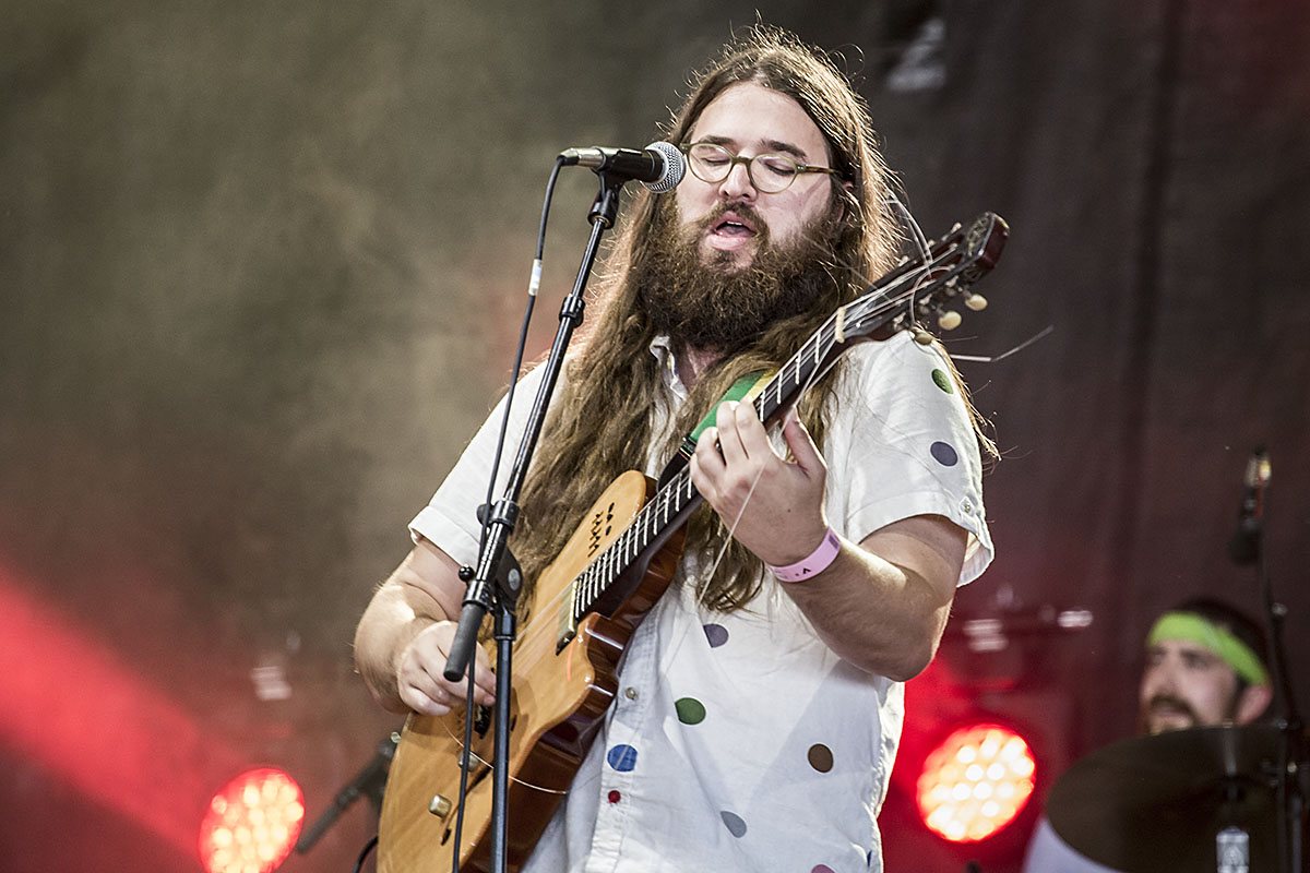 Matthew E. White singing and playing guitar with his band at Roskilde Festival, Denmark, 2013