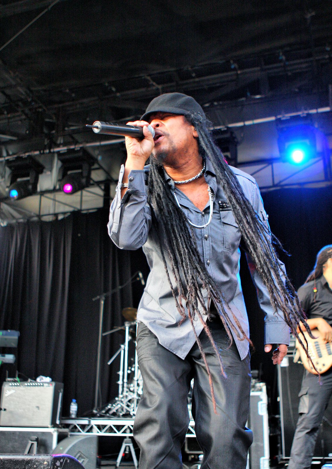 Maxi Priest singing into a microphone on stage at the Raggamuffin Music Festival, 2011