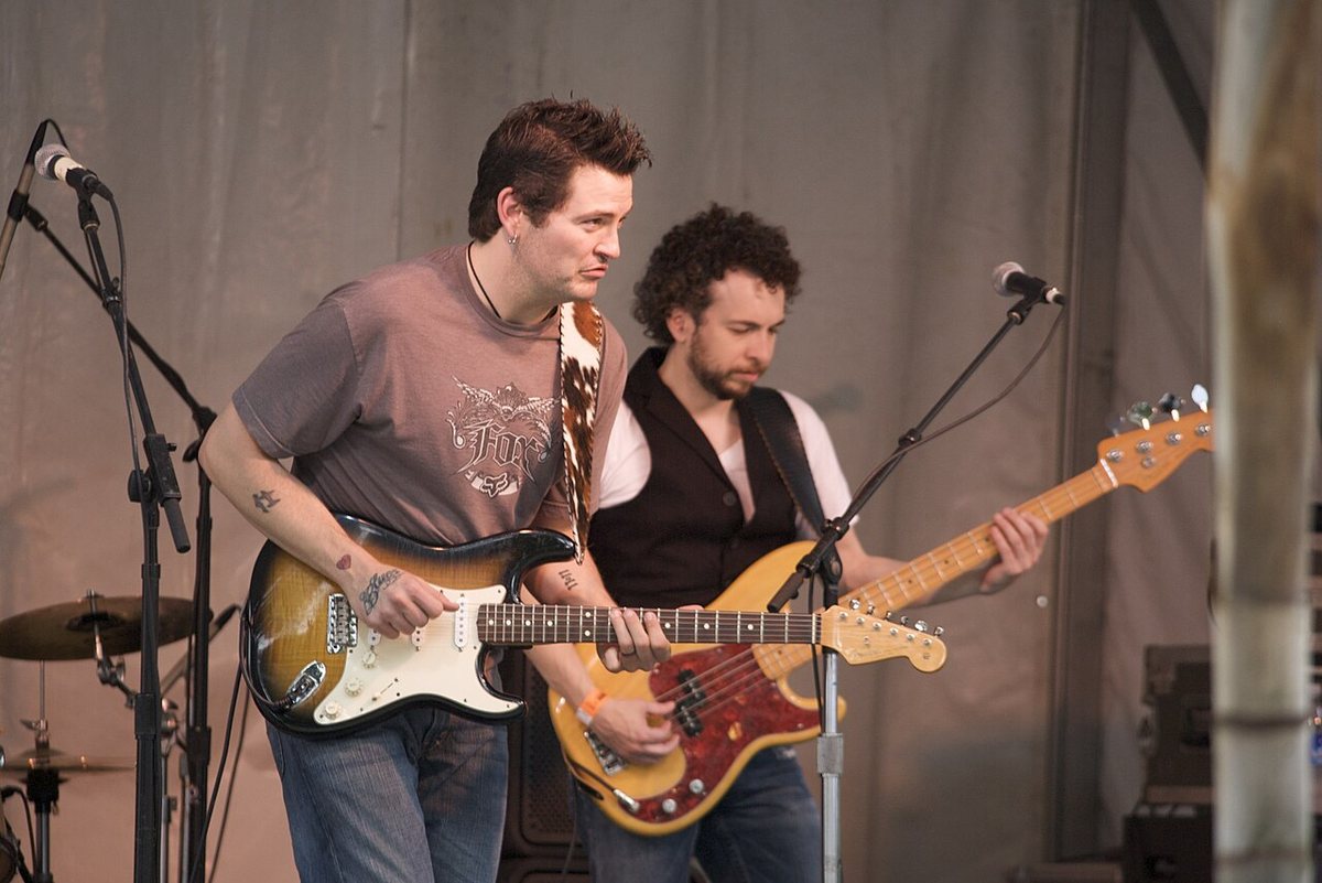 Buy Mike Zito tickets on StubOrder Mike Zito playing electric guitar beside his bassist at the Houston International Festival, 2009