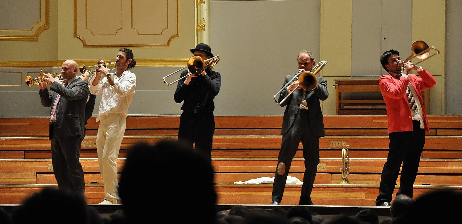 Mnozil Brass playing trumpets and trombones on stage at the Laeiszhalle, Hamburg, 2012