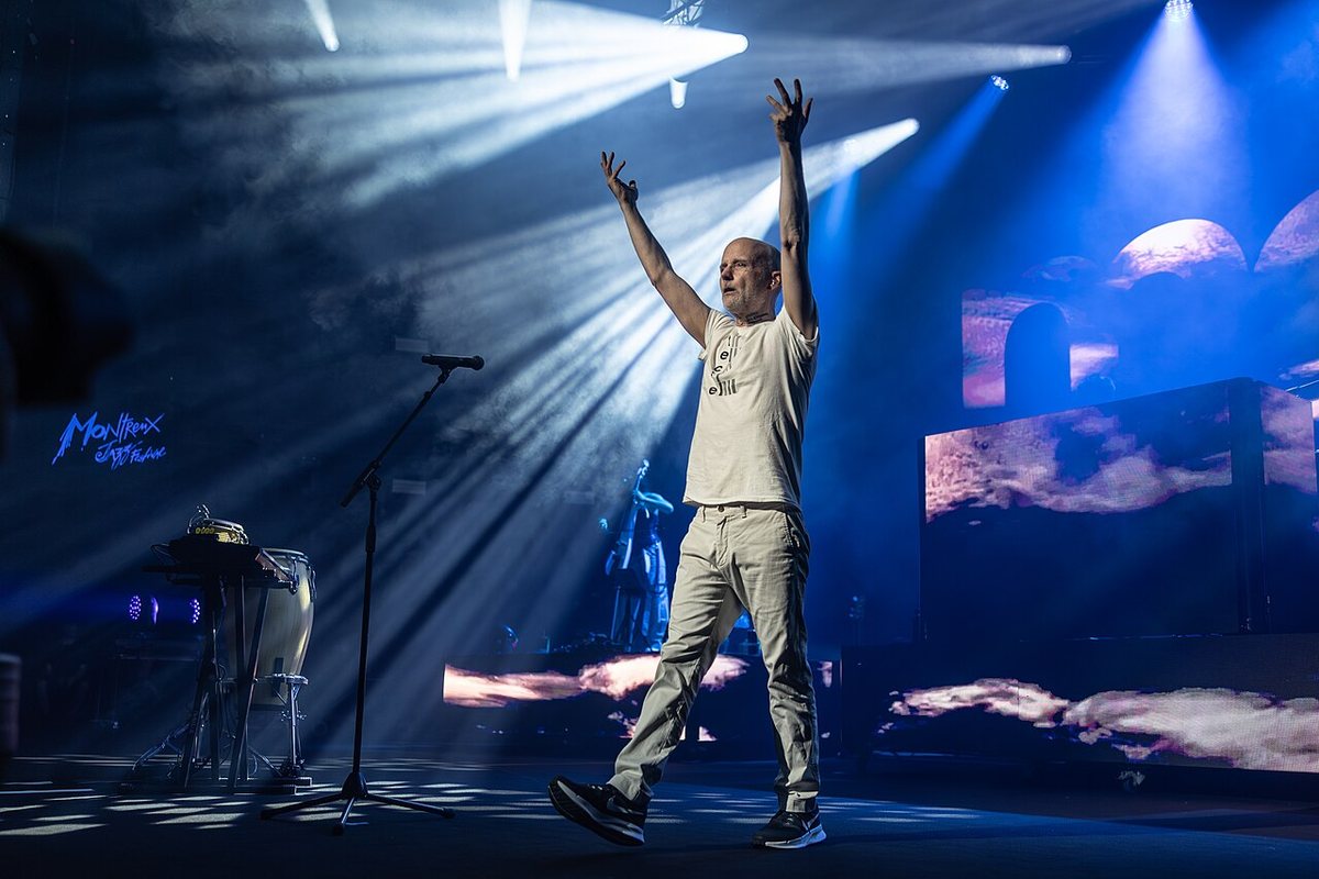 Moby with arms raised under stage lights at the Montreux Jazz Festival, 2026